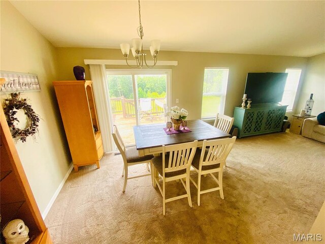 145 Champions Ln, Wentzville, MO 63385 - dining area with a chandelier, light colored carpet, and healthy amount of natural light