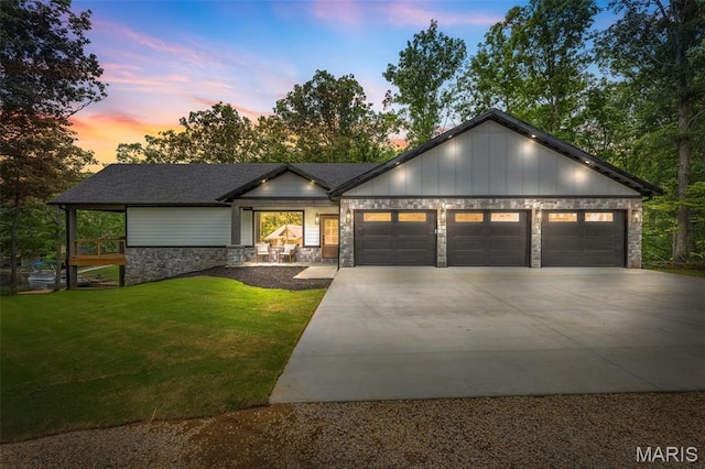 10028 Debbie Pl, Bonne Terre, MO 63628 - view of front of property featuring stone siding, a garage, driveway, and a front yard