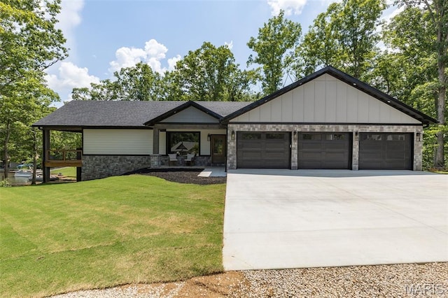 10028 Debbie Pl, Bonne Terre, MO 63628 - view of front of home with a garage, stone siding, concrete driveway, a front lawn, and board and batten siding