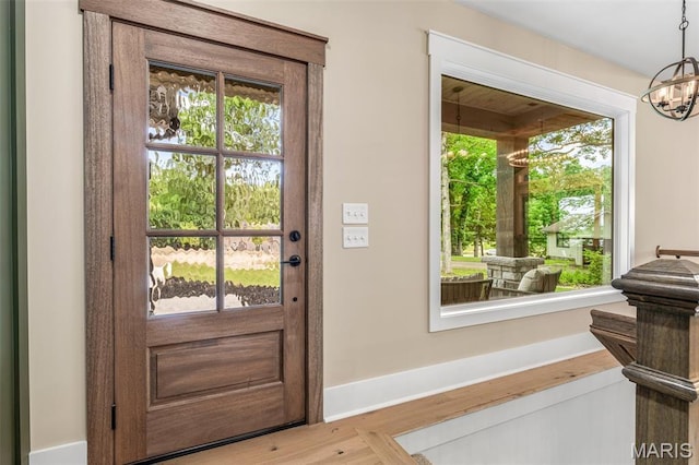 10028 Debbie Pl, Bonne Terre, MO 63628 - doorway featuring healthy amount of natural light, a chandelier, and wood finished floors