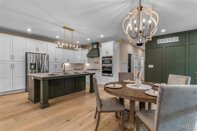 10028 Debbie Pl, Bonne Terre, MO 63628 - dining area featuring a chandelier, light wood finished floors, and recessed lighting