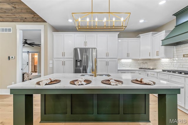 10028 Debbie Pl, Bonne Terre, MO 63628 - kitchen with stainless steel appliances, white cabinetry, premium range hood, a large island with sink, and recessed lighting