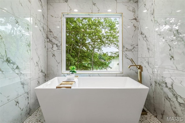 10028 Debbie Pl, Bonne Terre, MO 63628 - bathroom featuring healthy amount of natural light, a freestanding bath, and tile walls