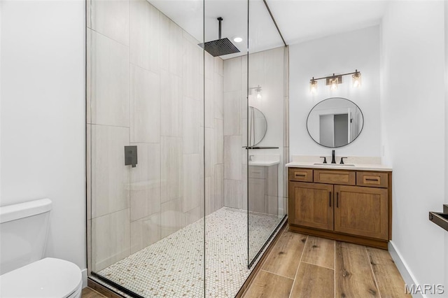 10028 Debbie Pl, Bonne Terre, MO 63628 - bathroom with tiled shower, vanity, wood finished floors, and recessed lighting