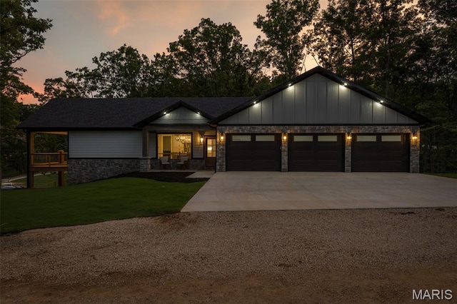 10028 Debbie Pl, Bonne Terre, MO 63628 - view of front of house featuring an attached garage, concrete driveway, stone siding, a front lawn, and board and batten siding