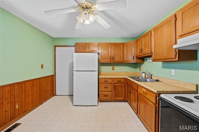237 Perrottet Dr, Mascoutah, IL 62258 - kitchen featuring freestanding refrigerator, light countertops, wainscoting, light flooring, and range with electric cooktop