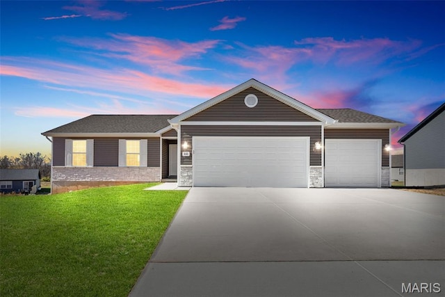 912 Gimli Ln, Wright City, MO 63390 - ranch-style home featuring an attached garage, concrete driveway, a front lawn, and stone siding