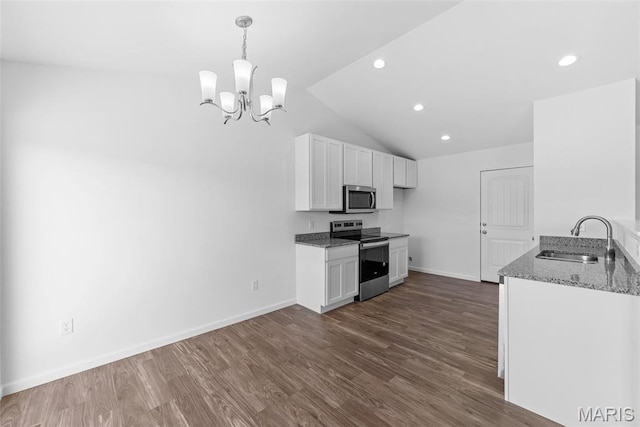 912 Gimli Ln, Wright City, MO 63390 - kitchen featuring appliances with stainless steel finishes, stone counters, vaulted ceiling, a chandelier, and white cabinetry