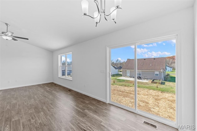 912 Gimli Ln, Wright City, MO 63390 - unfurnished dining area with lofted ceiling, a chandelier, wood finished floors, and a ceiling fan