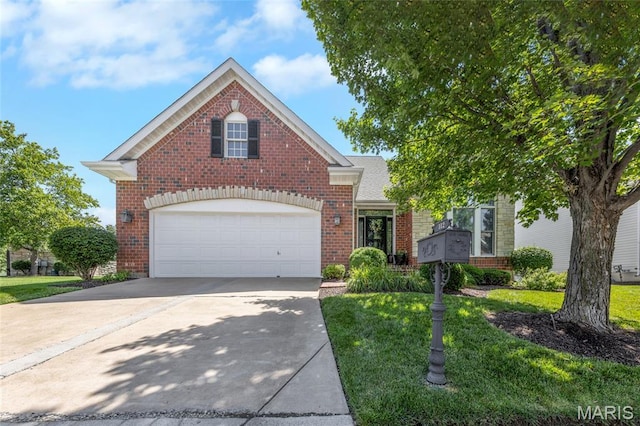 112 Wake Forest Pl, Ofallon, MO 63368 - traditional-style home with brick siding, driveway, and a front yard