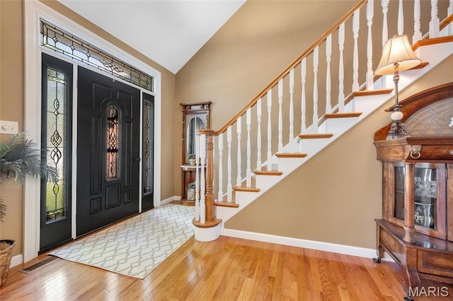 112 Wake Forest Pl, Ofallon, MO 63368 - entrance foyer with vaulted ceiling, wood finished floors, and stairs