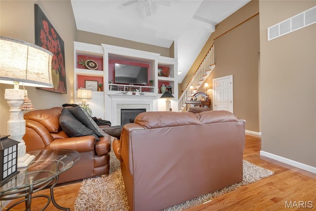 112 Wake Forest Pl, Ofallon, MO 63368 - living area featuring stairs, a fireplace, a ceiling fan, and wood finished floors