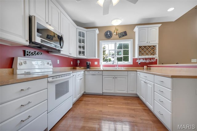 112 Wake Forest Pl, Ofallon, MO 63368 - kitchen featuring white appliances, a peninsula, glass insert cabinets, white cabinetry, and recessed lighting
