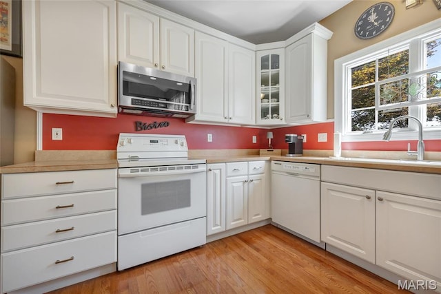112 Wake Forest Pl, Ofallon, MO 63368 - kitchen featuring white appliances, glass insert cabinets, light wood finished floors, and light countertops