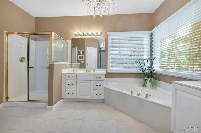 112 Wake Forest Pl, Ofallon, MO 63368 - full bathroom with a chandelier, vanity, a stall shower, a garden tub, and tile patterned floors
