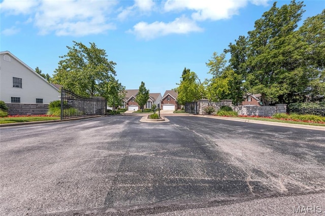 112 Wake Forest Pl, Ofallon, MO 63368 - view of asphalt street with curbs, a gate, and a residential view