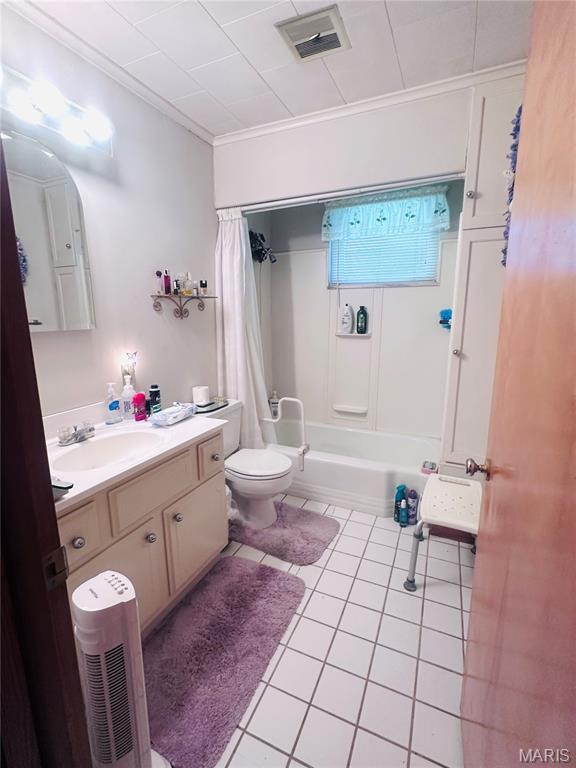 1620 N Jefferson St, Mexico, MO 65265 - full bath featuring crown molding, vanity, tile patterned flooring, and shower / bathtub combination with curtain
