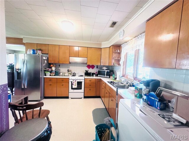 1620 N Jefferson St, Mexico, MO 65265 - kitchen featuring appliances with stainless steel finishes, under cabinet range hood, light countertops, open shelves, and backsplash