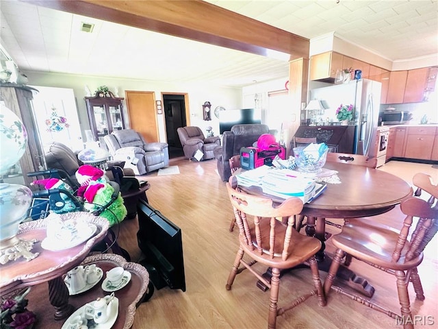1620 N Jefferson St, Mexico, MO 65265 - dining space with light wood finished floors and beam ceiling