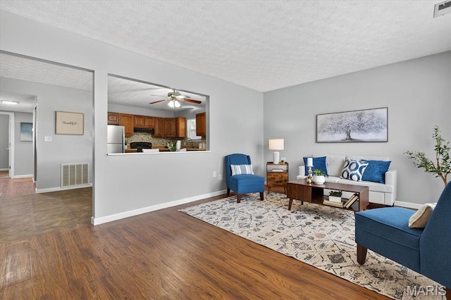 117 1st Ave, Edwardsville, IL 62025 - living room with dark wood finished floors, a textured ceiling, and ceiling fan