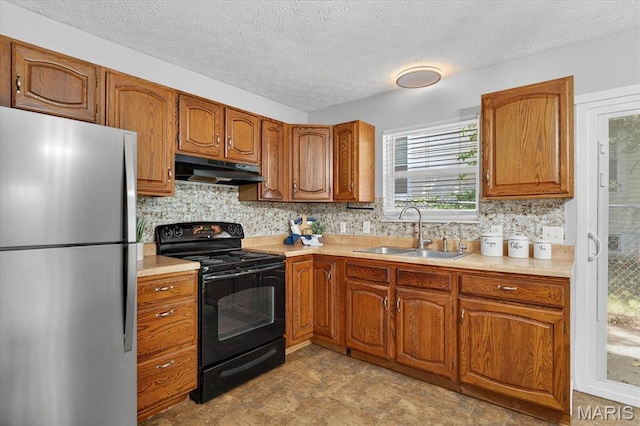 117 1st Ave, Edwardsville, IL 62025 - kitchen with freestanding refrigerator, black range with electric stovetop, under cabinet range hood, light countertops, and a textured ceiling