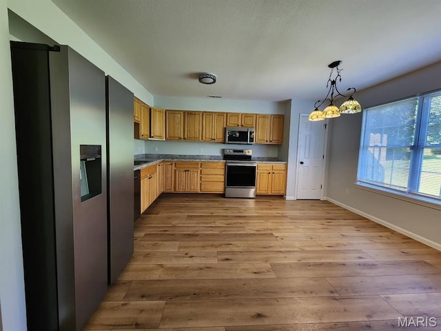 1604 Napoleon Dr, Bonne Terre, MO 63628 - kitchen featuring stainless steel appliances, light wood-style flooring, and decorative light fixtures