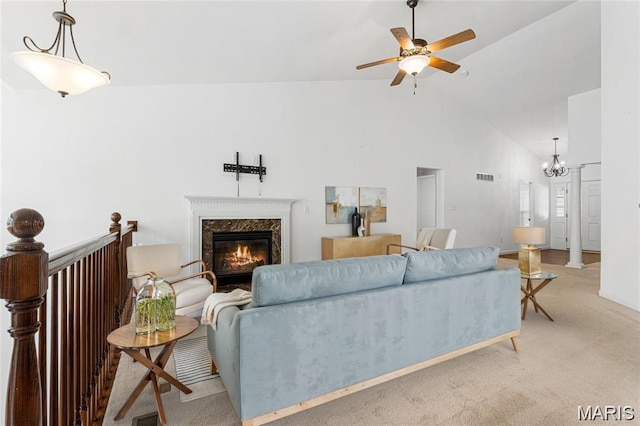 524 Pleasant Breeze Dr, Wentzville, MO 63385 - living area with a fireplace, a ceiling fan, light colored carpet, high vaulted ceiling, and a chandelier