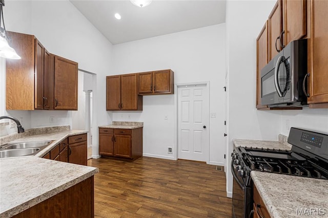 524 Pleasant Breeze Dr, Wentzville, MO 63385 - kitchen featuring black gas stove, dark wood-type flooring, light countertops, brown cabinets, and recessed lighting