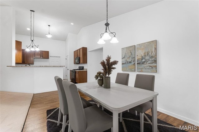 524 Pleasant Breeze Dr, Wentzville, MO 63385 - dining space with lofted ceiling, wood finished floors, recessed lighting, and a chandelier