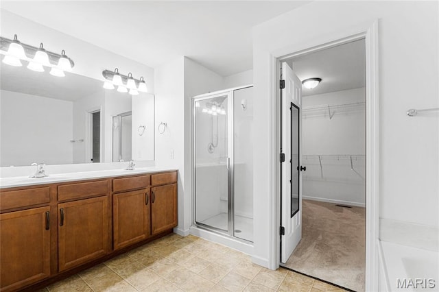 524 Pleasant Breeze Dr, Wentzville, MO 63385 - bathroom with a stall shower, a walk in closet, double vanity, and tile patterned floors