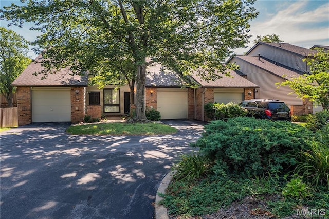1756 Pineberry Ct, Creve Coeur Township, MO 63146 - obstructed view of property featuring driveway, brick siding, and an attached garage