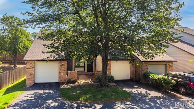 1756 Pineberry Ct, Creve Coeur Township, MO 63146 - obstructed view of property featuring brick siding, driveway, a garage, and a shingled roof
