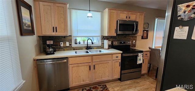208 S Bast St, Jackson, MO 63755 - kitchen featuring stainless steel appliances, light brown cabinets, light countertops, and decorative backsplash