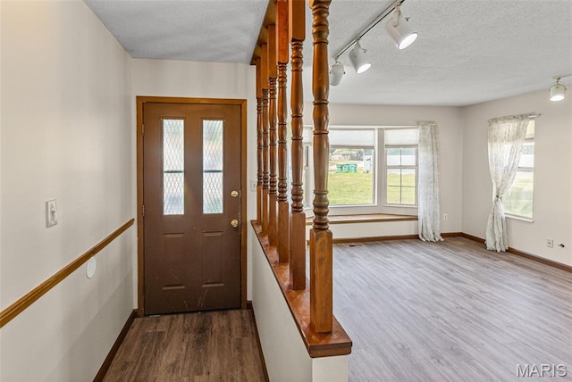 1520 Royal Oak Ct, Ofallon, IL 62269 - doorway to outside featuring track lighting, a textured ceiling, dark wood-style floors, and stairs