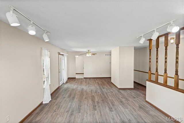 1520 Royal Oak Ct, Ofallon, IL 62269 - unfurnished living room with rail lighting, a ceiling fan, and wood finished floors
