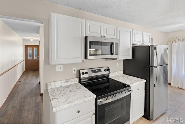 1520 Royal Oak Ct, Ofallon, IL 62269 - kitchen with appliances with stainless steel finishes, light countertops, white cabinetry, and a textured ceiling