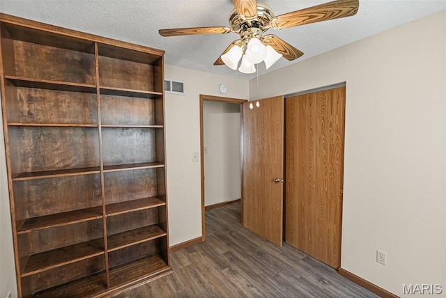 1520 Royal Oak Ct, Ofallon, IL 62269 - unfurnished bedroom with a closet, dark wood finished floors, a textured ceiling, and a ceiling fan