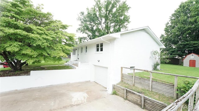 850 Cambridge Dr, Sikeston, MO 63801 - view of side of property with concrete driveway, an attached garage, and a shed
