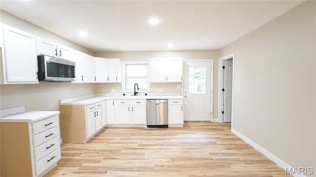 850 Cambridge Dr, Sikeston, MO 63801 - kitchen with stainless steel appliances, light wood-type flooring, recessed lighting, white cabinetry, and light countertops