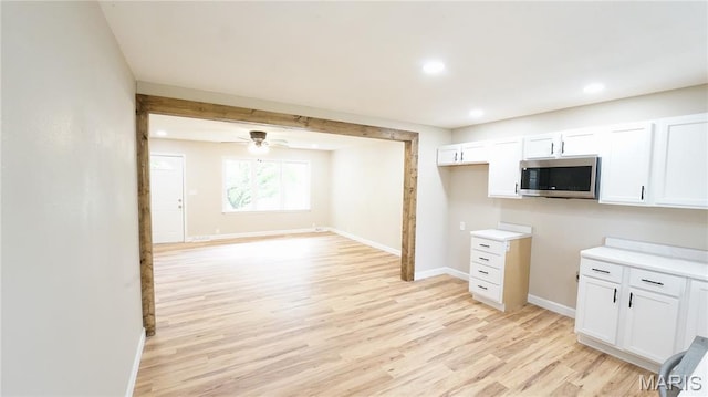 850 Cambridge Dr, Sikeston, MO 63801 - kitchen featuring stainless steel microwave, light wood-style flooring, recessed lighting, white cabinetry, and ceiling fan