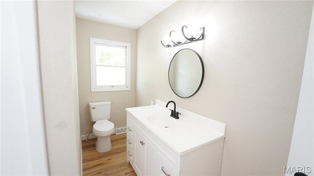 850 Cambridge Dr, Sikeston, MO 63801 - half bath featuring vanity and wood finished floors