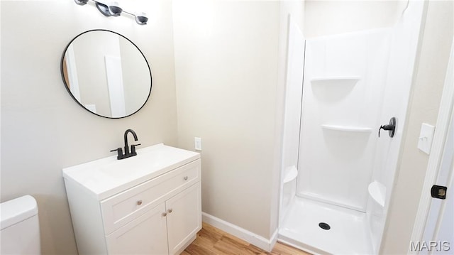 850 Cambridge Dr, Sikeston, MO 63801 - bathroom featuring vanity, a walk in shower, and wood finished floors