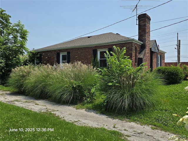 6203 Dardanella Ave, Normandy, MO 63121 - view of side of home with a chimney and brick siding