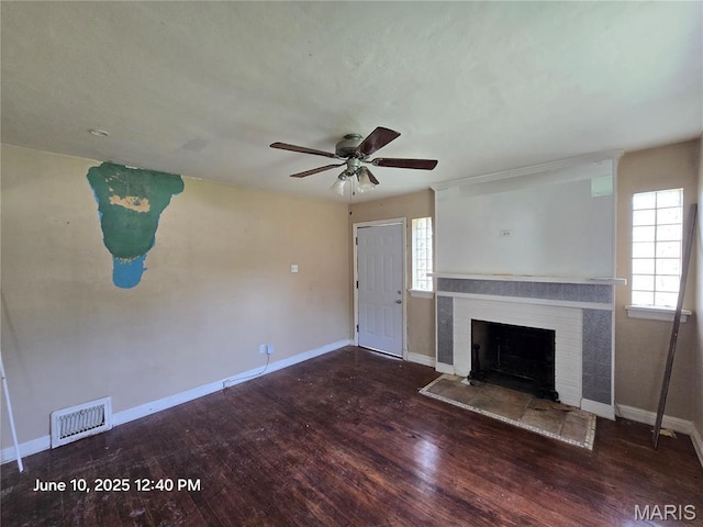 6203 Dardanella Ave, Normandy, MO 63121 - unfurnished living room with wood finished floors, a brick fireplace, and a ceiling fan