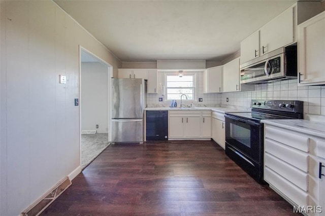 12575 State Route F, Rolla, MO 65401 - kitchen with black appliances, light countertops, dark wood finished floors, and tasteful backsplash