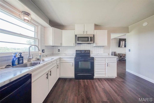 12575 State Route F, Rolla, MO 65401 - kitchen featuring stainless steel microwave, black range with electric cooktop, dishwashing machine, dark wood finished floors, and decorative backsplash