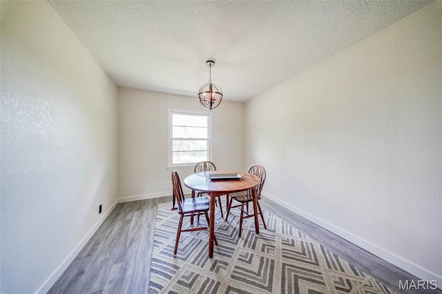 12575 State Route F, Rolla, MO 65401 - dining space featuring a chandelier, wood finished floors, and a textured ceiling