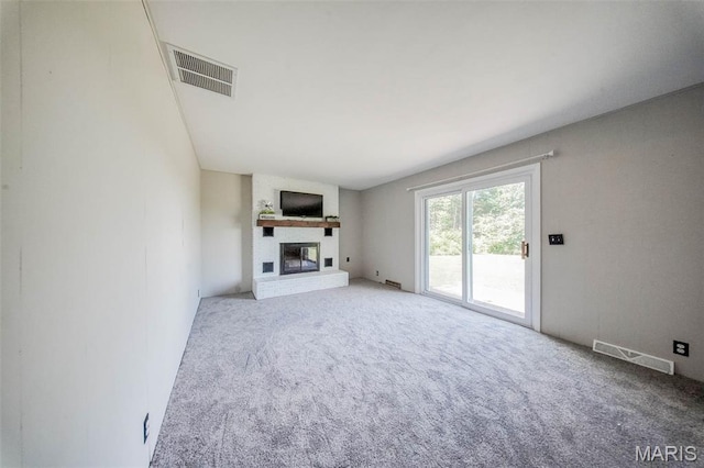 12575 State Route F, Rolla, MO 65401 - unfurnished living room featuring carpet flooring and a brick fireplace