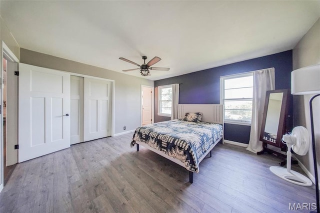 12575 State Route F, Rolla, MO 65401 - bedroom featuring wood finished floors, a closet, and a ceiling fan