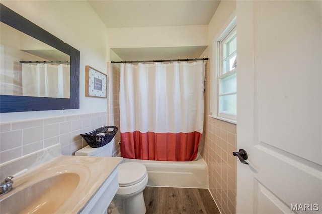12575 State Route F, Rolla, MO 65401 - bathroom with tile walls, vanity, wood finished floors, shower / tub combo with curtain, and a wainscoted wall